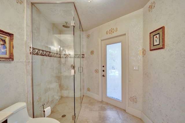 bathroom featuring a textured ceiling, toilet, and walk in shower