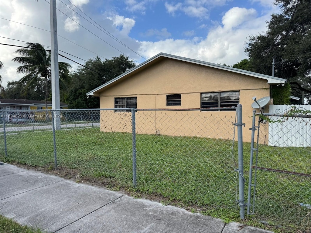 view of property exterior with a yard