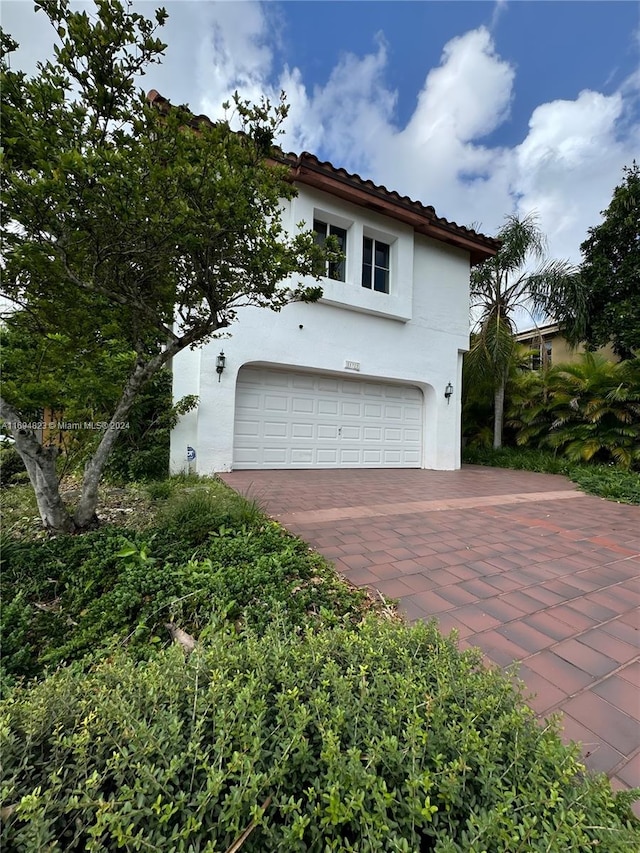 mediterranean / spanish house with a garage