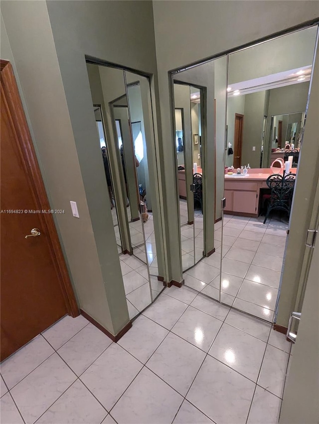 hall with light tile patterned floors