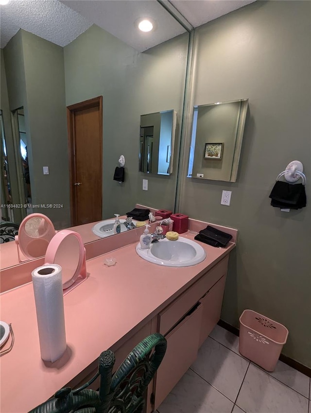 bathroom featuring tile patterned flooring and vanity