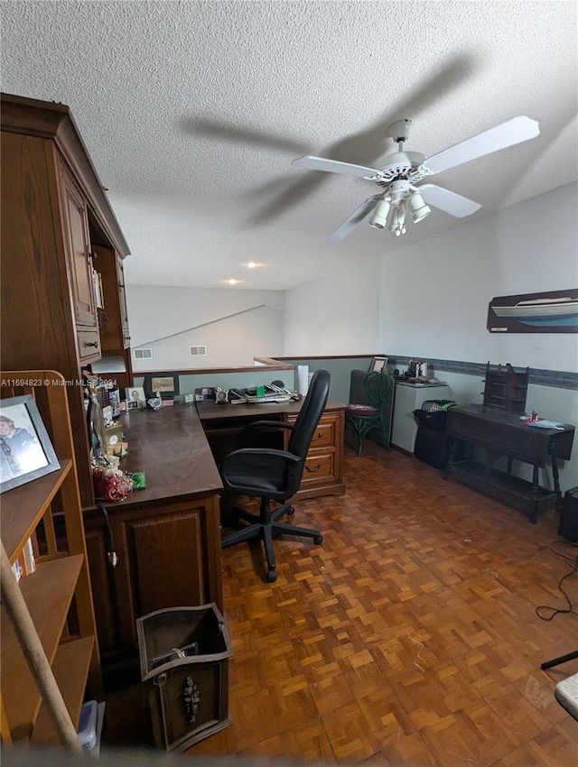 office area with ceiling fan, a textured ceiling, and dark parquet floors