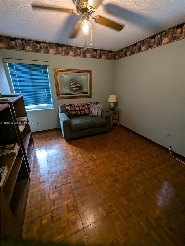 unfurnished room with ceiling fan and a textured ceiling