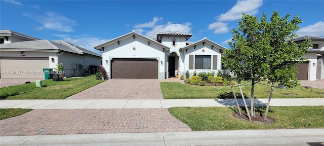 mediterranean / spanish home with a garage, a front lawn, and central air condition unit