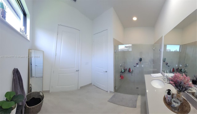 bathroom featuring vanity, an enclosed shower, and lofted ceiling