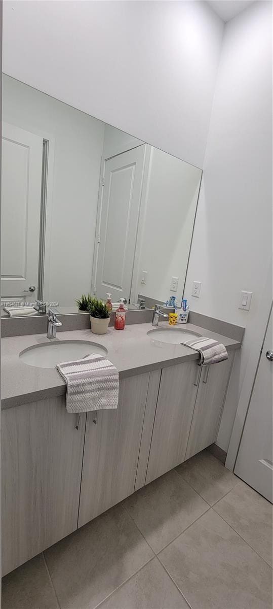 bathroom featuring tile patterned flooring and vanity