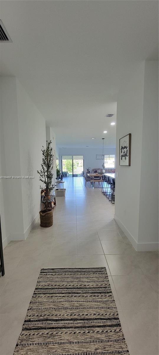 hall featuring light tile patterned floors