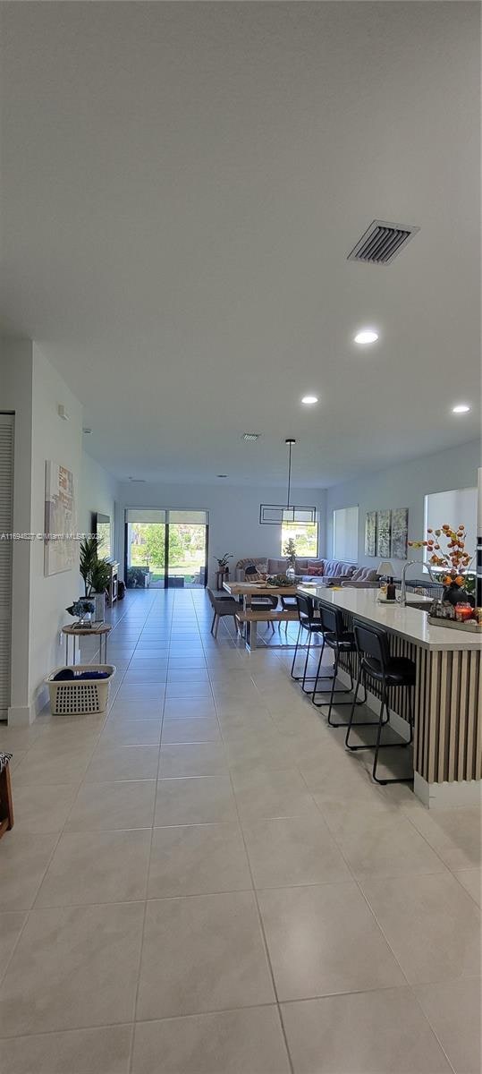 unfurnished dining area featuring light tile patterned floors and sink