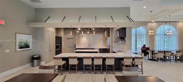 interior space featuring a kitchen breakfast bar, kitchen peninsula, sink, and hanging light fixtures