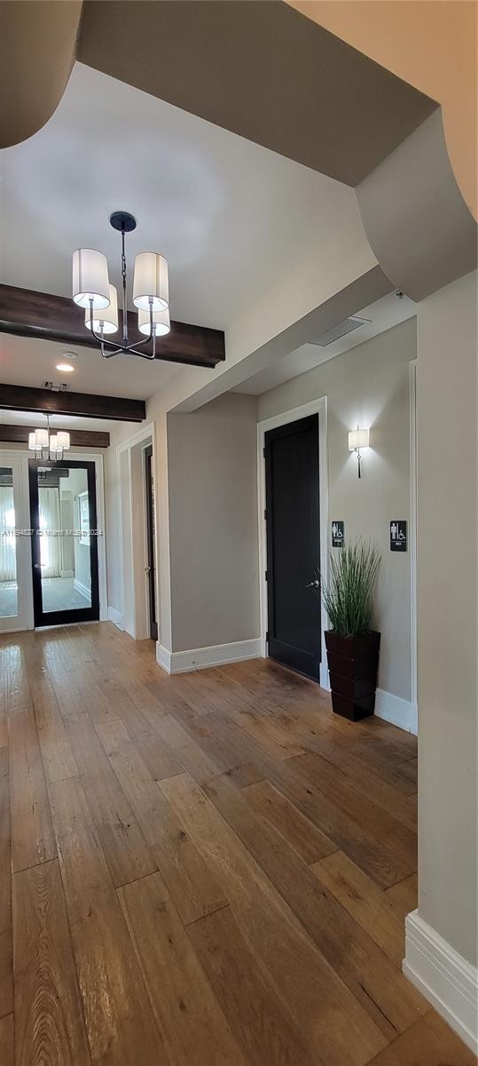 interior space featuring hardwood / wood-style floors and a chandelier