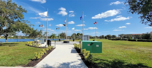 view of community with a water view and a lawn