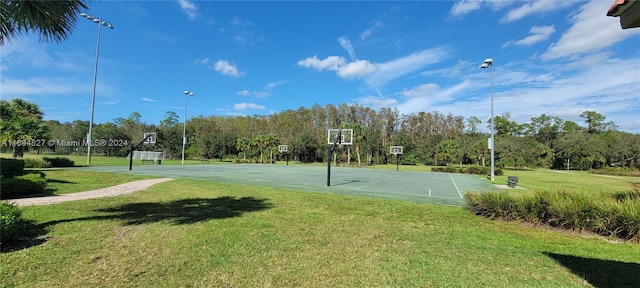 view of basketball court with a lawn