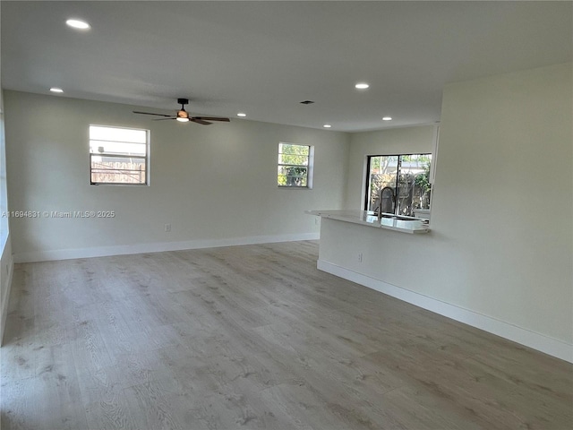 empty room featuring ceiling fan and light hardwood / wood-style flooring