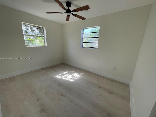 empty room with light hardwood / wood-style flooring and ceiling fan