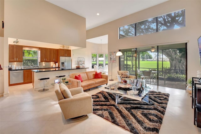 tiled living room with a high ceiling and a wealth of natural light