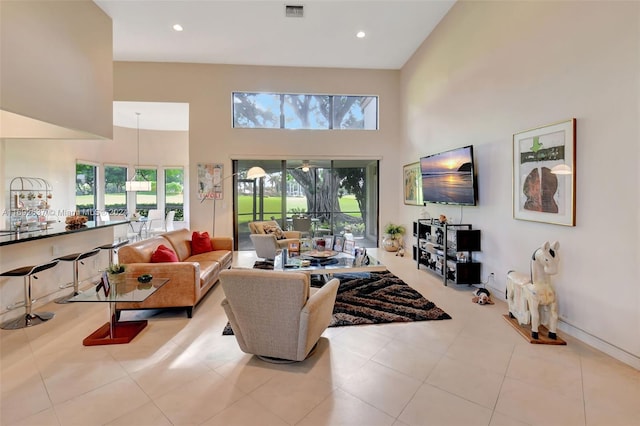 tiled living room featuring a towering ceiling