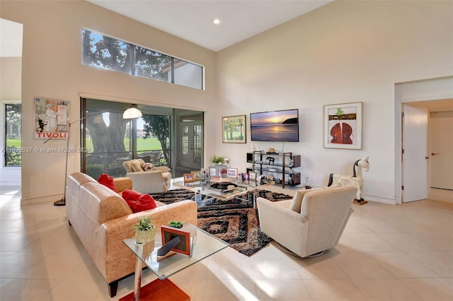 tiled living room with a towering ceiling and a wealth of natural light