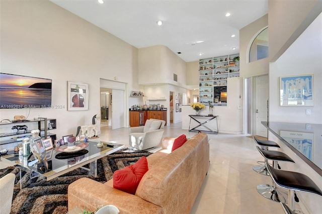 living room featuring a towering ceiling