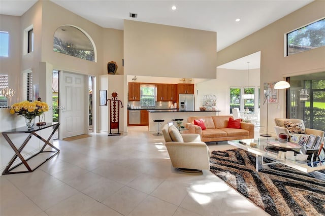 tiled living room featuring a towering ceiling