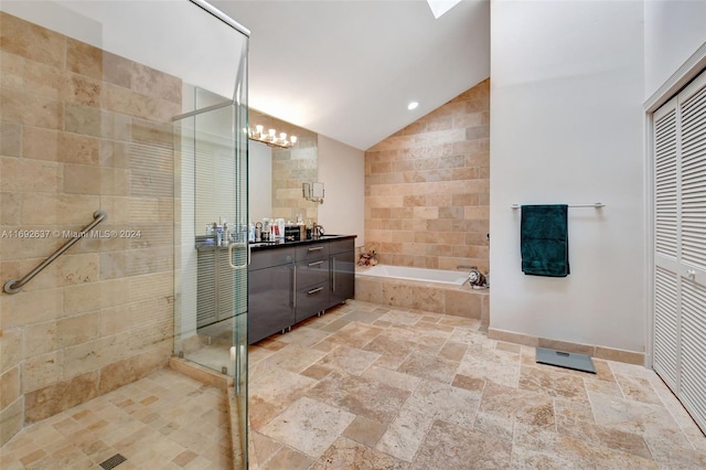 bathroom with vanity, separate shower and tub, and vaulted ceiling