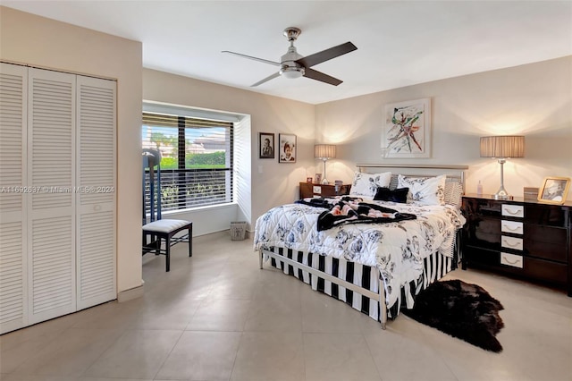 bedroom with ceiling fan, light tile patterned flooring, and a closet