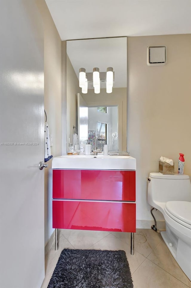 bathroom featuring tile patterned flooring, vanity, and toilet