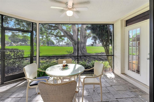 sunroom featuring ceiling fan