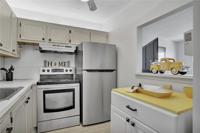 4107 E Cambridge E Unit 4107, Deerfield Beach, FL 33442 - kitchen featuring appliances with stainless steel finishes, under cabinet range hood, light countertops, light wood-style floors, and ceiling fan