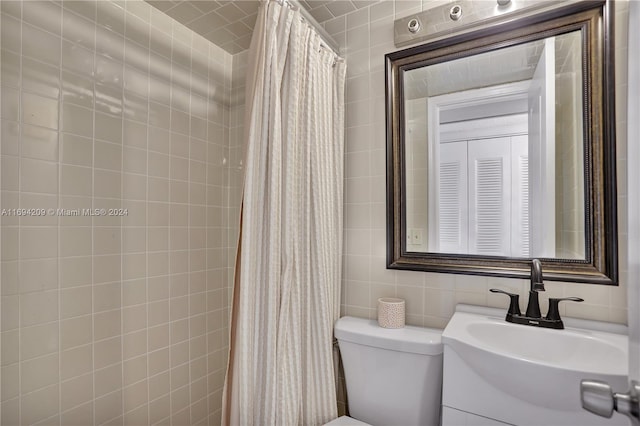 bathroom with vanity, decorative backsplash, toilet, tile walls, and curtained shower