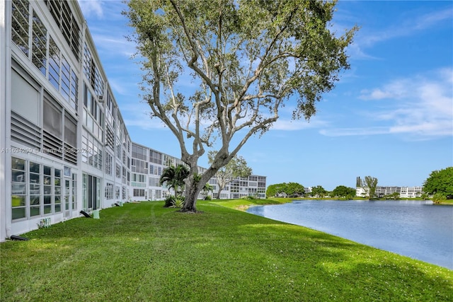 exterior space featuring a lawn and a water view