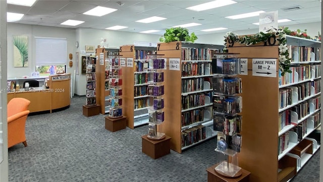 4107 E Cambridge E Unit 4107, Deerfield Beach, FL 33442 - office with bookshelves, carpet floors, and a paneled ceiling