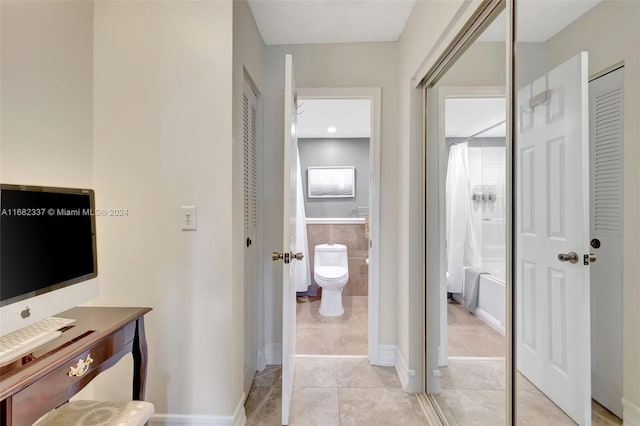 bathroom with tile patterned flooring, vanity, toilet, and a shower