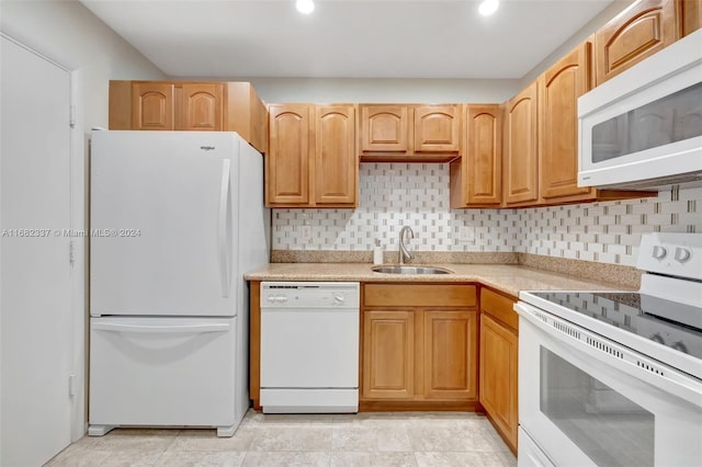 kitchen with decorative backsplash, sink, and white appliances