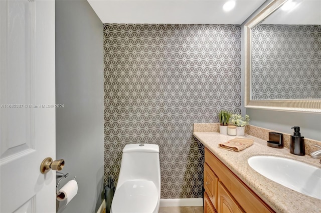 bathroom with vanity, toilet, and tile walls