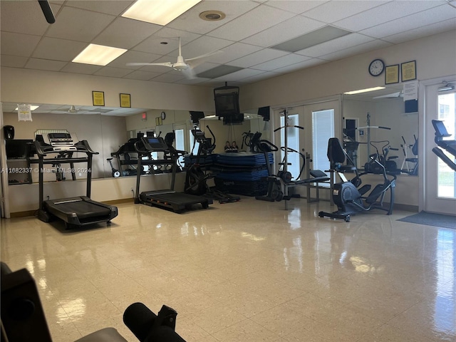 workout area with a paneled ceiling and ceiling fan