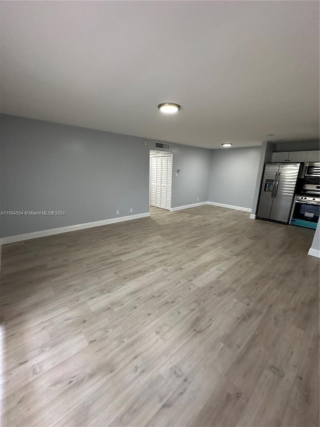 unfurnished living room with light wood-type flooring