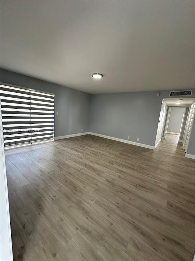 empty room with hardwood / wood-style floors