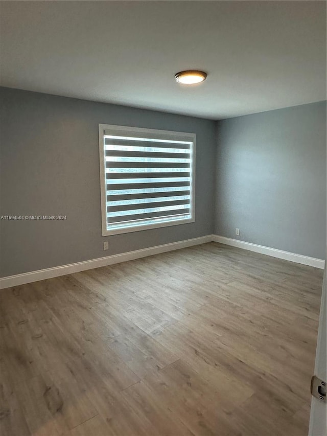 unfurnished room with light wood-type flooring