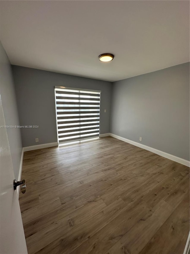 empty room with dark wood-type flooring