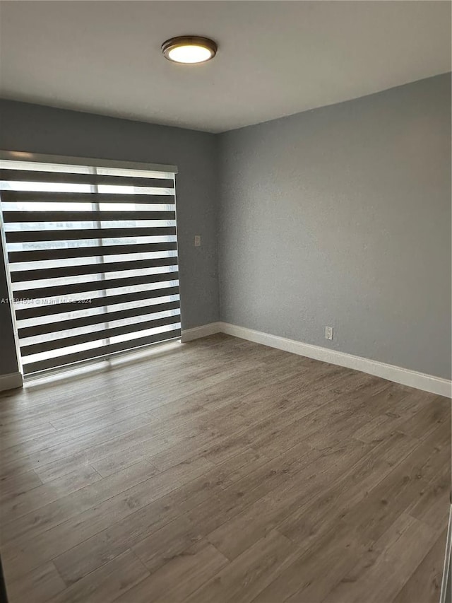 spare room featuring hardwood / wood-style floors