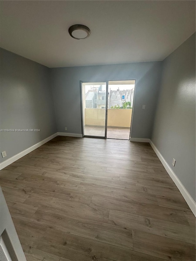 unfurnished room with hardwood / wood-style flooring