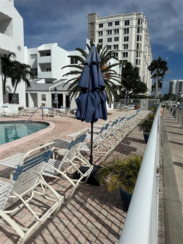 view of swimming pool featuring a patio area and central AC