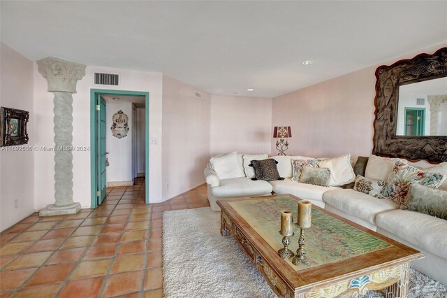 tiled living room featuring ornate columns