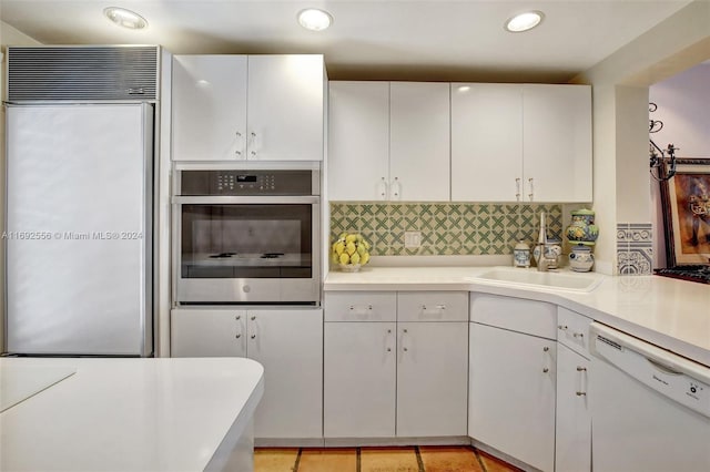 kitchen featuring white cabinetry, stainless steel appliances, and tasteful backsplash