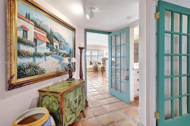 hallway featuring light tile patterned floors and french doors