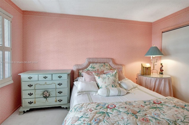 carpeted bedroom with crown molding