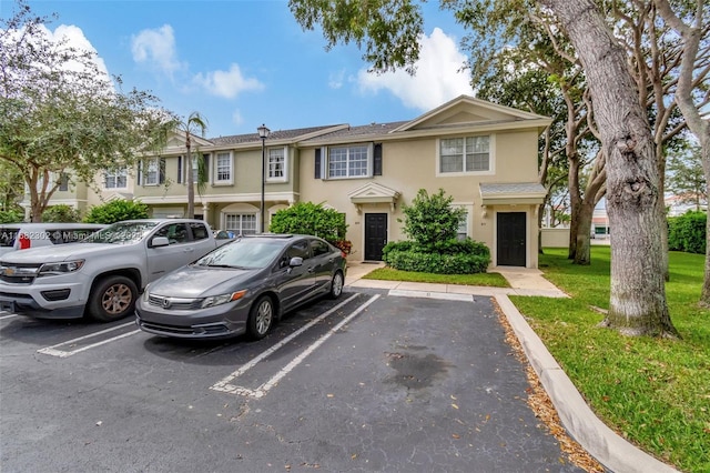 view of property featuring a front lawn