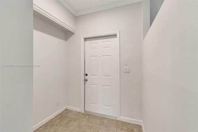 doorway to outside featuring crown molding