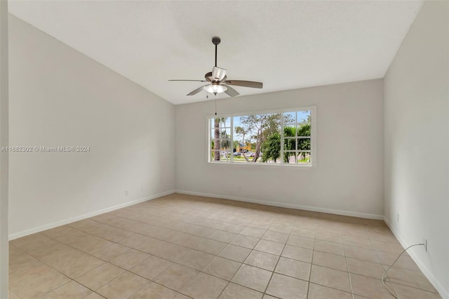 tiled empty room featuring ceiling fan