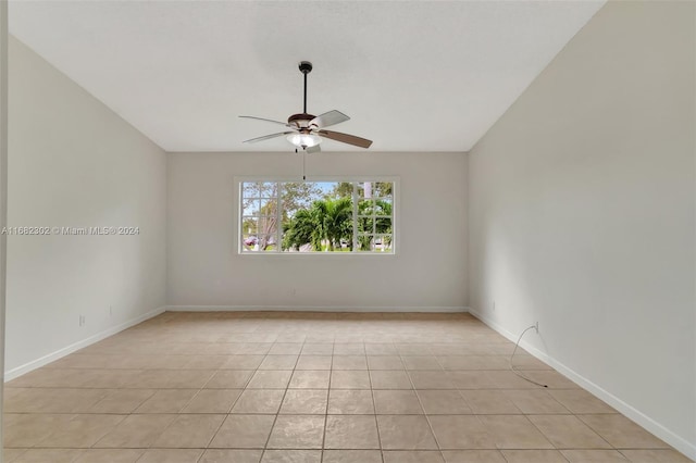 tiled spare room with ceiling fan